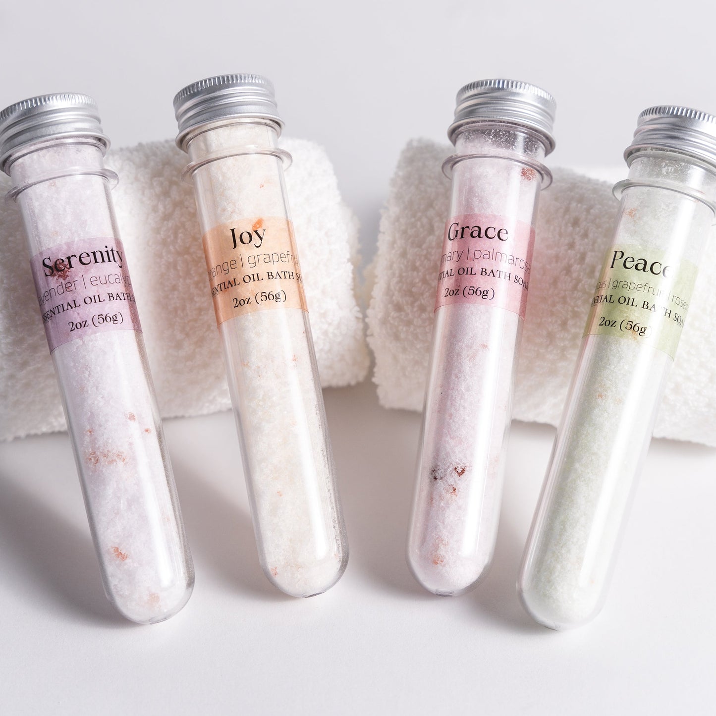 Handmade essential oil bath soak gift set from Megan’s Pantry includes four 2 oz tubes in signature scents: Serenity, Joy, Grace, and Peace. Made with natural salts and organic essential oils, beautifully packaged in a kraft gift box with pine shred and ribbon. Perfect spa-inspired gift for birthdays, showers, or relaxing self-care rituals