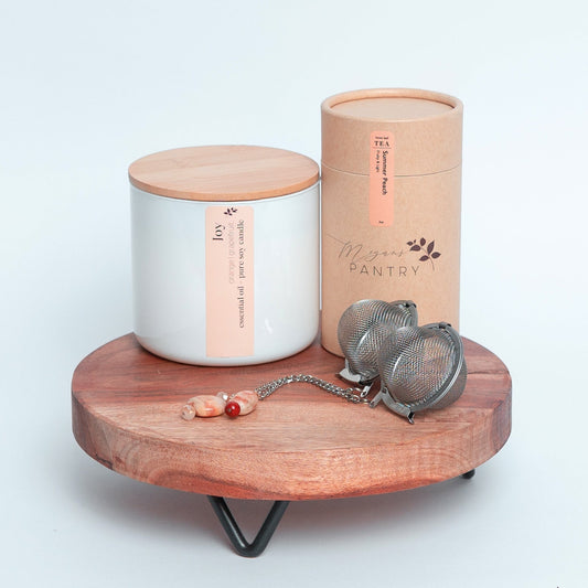 Share a moment of joy with the Tea for Two Gift Set from Megan’s Pantry — a charming tea and candle gift box perfect for birthdays, anniversaries, thank-you gifts, or simply brightening someone’s day. This thoughtfully curated set includes our best-selling Summer Peach Tea, a radiant Joy Essential Oil Candle, and two sparkling gemmed tea ball infusers for a beautiful, shared tea experience.