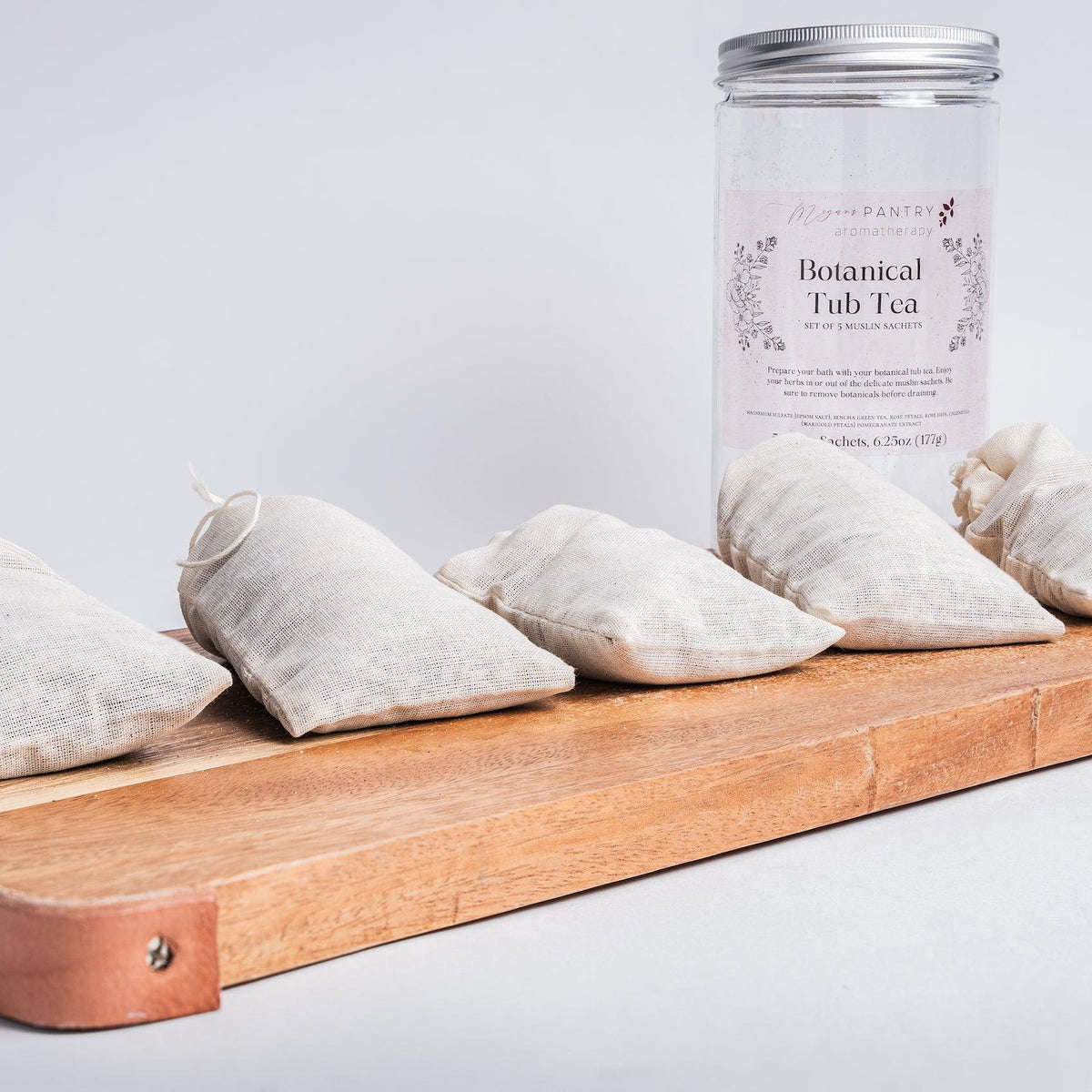 Megan's Pantry Botanical Tub Tea with muslin sachets of green tea, rose, hibiscus, and marigold for the bath.