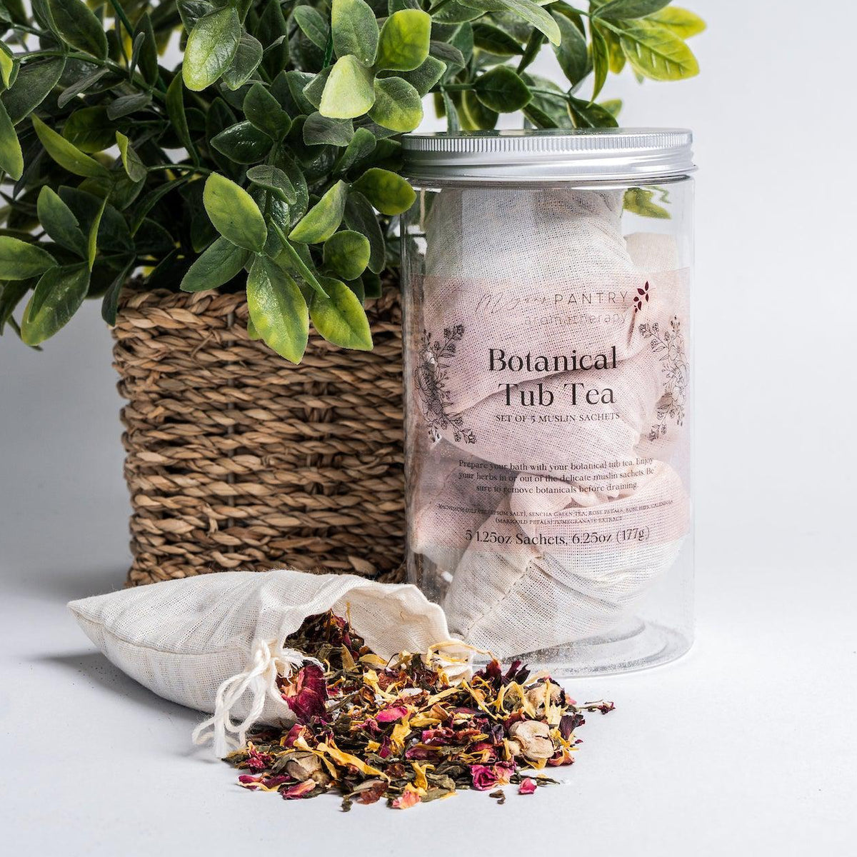 Megan's Pantry Botanical Tub Tea with muslin sachets of green tea, rose, hibiscus, and marigold for the bath.