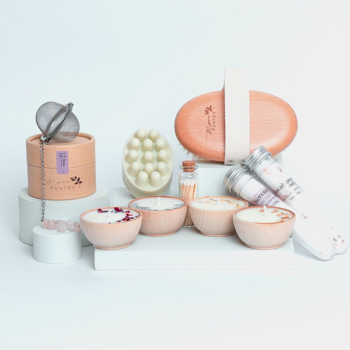 Perfect Spa Day Gift Set from Megan’s Pantry featuring four essential oil wooden tealight candles, matches, Serenity and Eucalyptus bath soaks, Peace triple butter body bar, natural body brush, Relax herbal tea, and a gemmed stainless steel tea infuser. A luxury wellness gift box for relaxation and self-care.