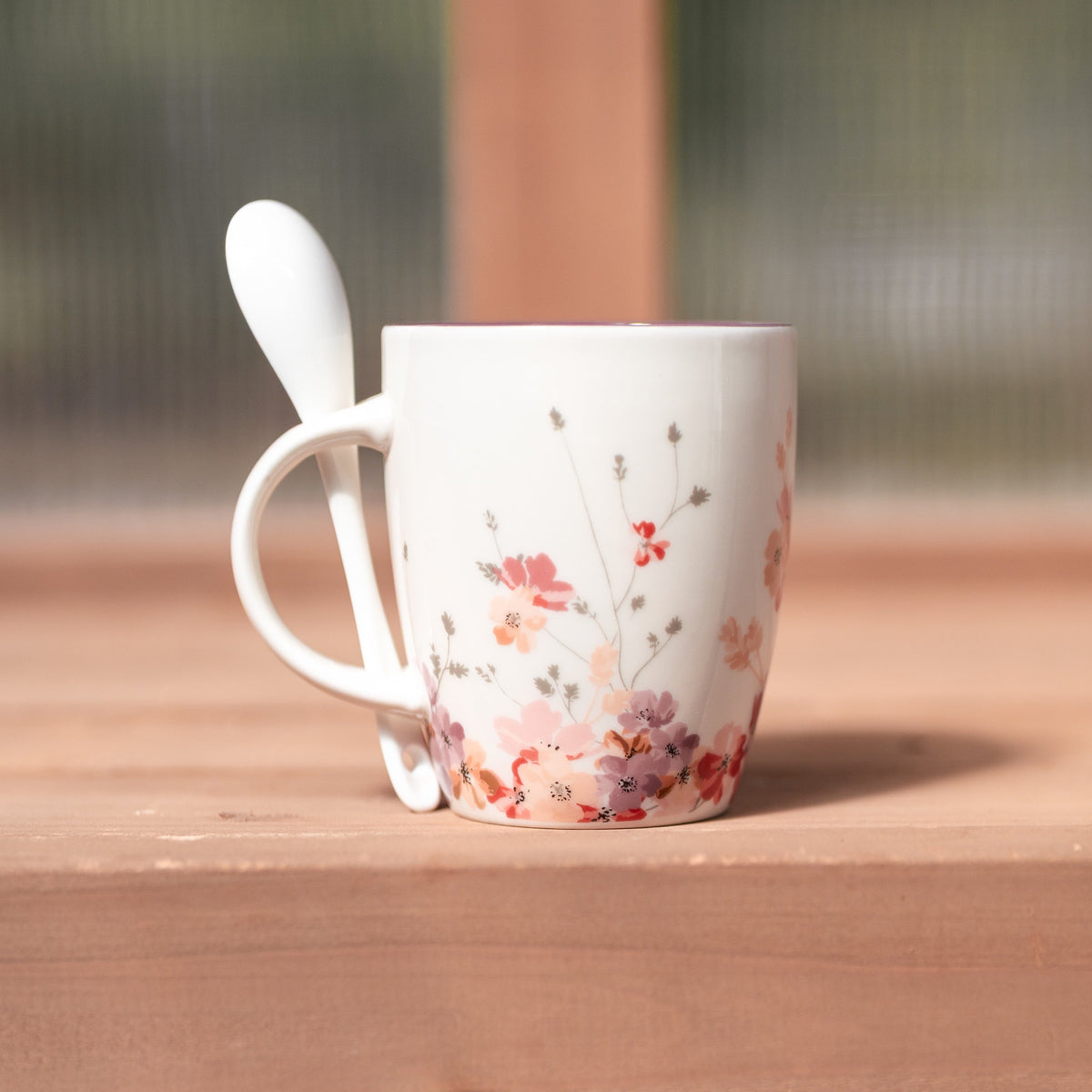 Megan's Pantry Be Still and Know mug with cosmos florals, glossy plum interior, and a matching spoon.