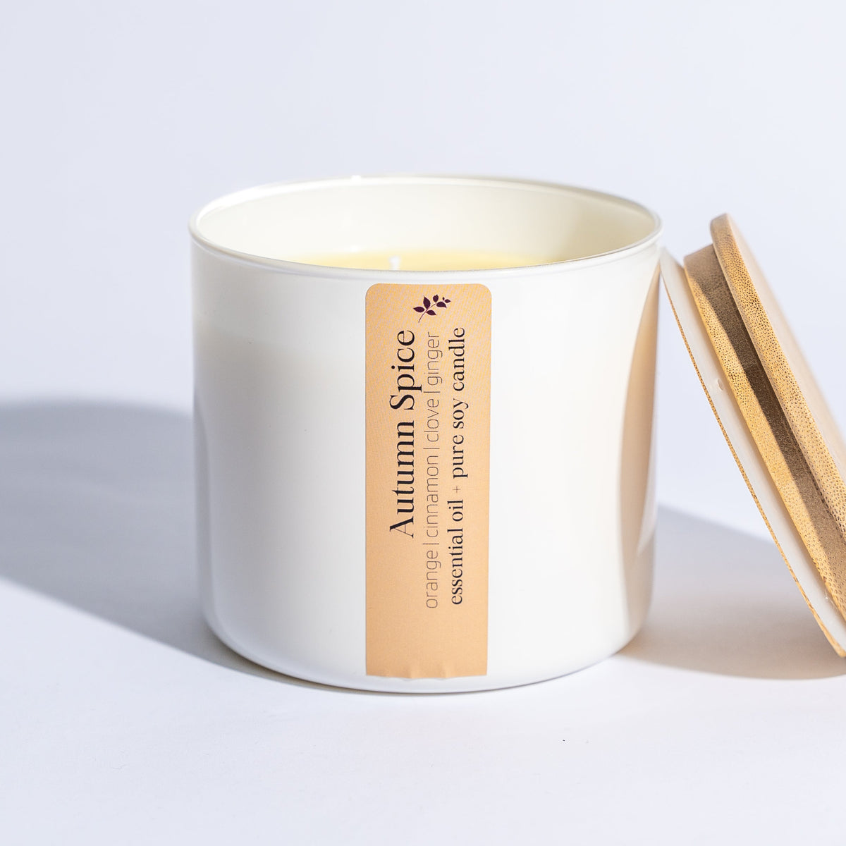 Autumn Spice 16 oz soy candle from Megan's Pantry in a glass jar with bamboo lid, scented with orange, cinnamon, and clove.