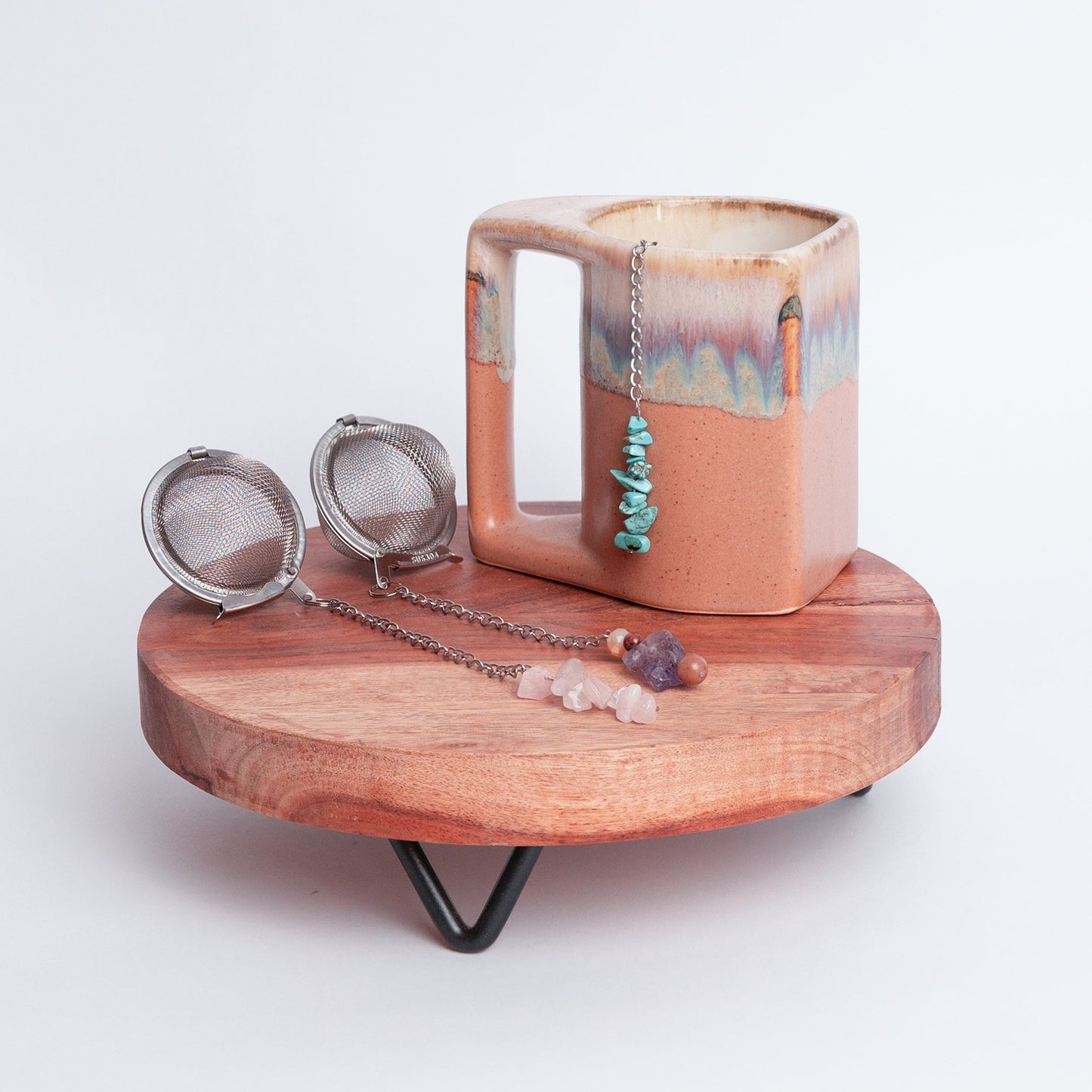 Handmade gemmed tea infuser ball from Megan’s Pantry featuring a large 2.5" stainless steel mesh for loose leaf tea. Each infuser includes a unique locally sourced gemstone charm. Crafted by Megan in Albuquerque NM this artisan tea accessory combines beauty and function and makes a perfect gift for tea lovers and wellness enthusiasts.