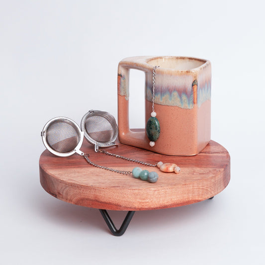 Handmade gemmed tea infuser ball from Megan’s Pantry featuring a large 2.5" stainless steel mesh for loose leaf tea. Each infuser includes a unique locally sourced gemstone charm. Crafted by Megan in Albuquerque NM this artisan tea accessory combines beauty and function and makes a perfect gift for tea lovers and wellness enthusiasts.