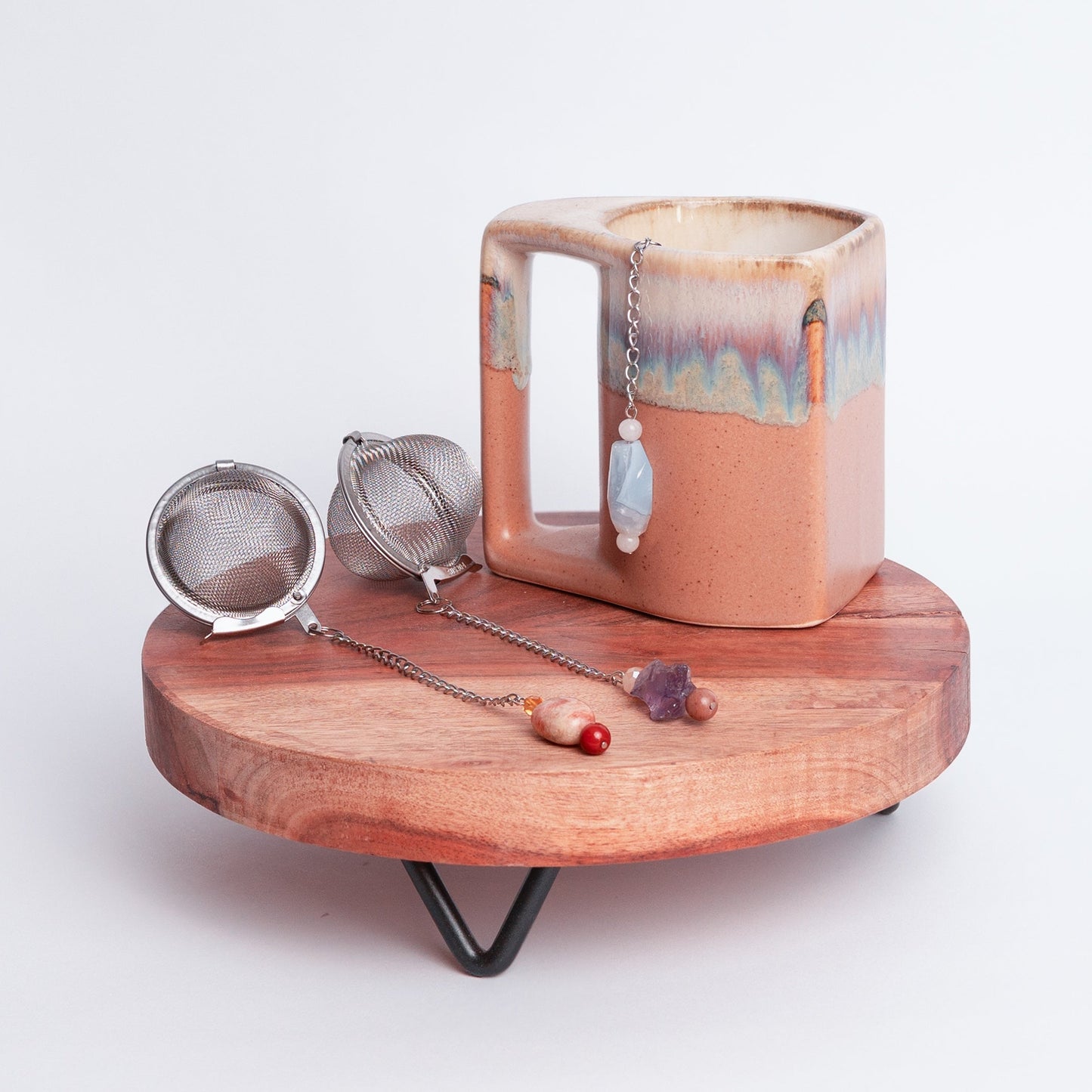 Handmade gemmed tea infuser ball from Megan’s Pantry featuring a large 2.5" stainless steel mesh for loose leaf tea. Each infuser includes a unique locally sourced gemstone charm. Crafted by Megan in Albuquerque NM this artisan tea accessory combines beauty and function and makes a perfect gift for tea lovers and wellness enthusiasts.