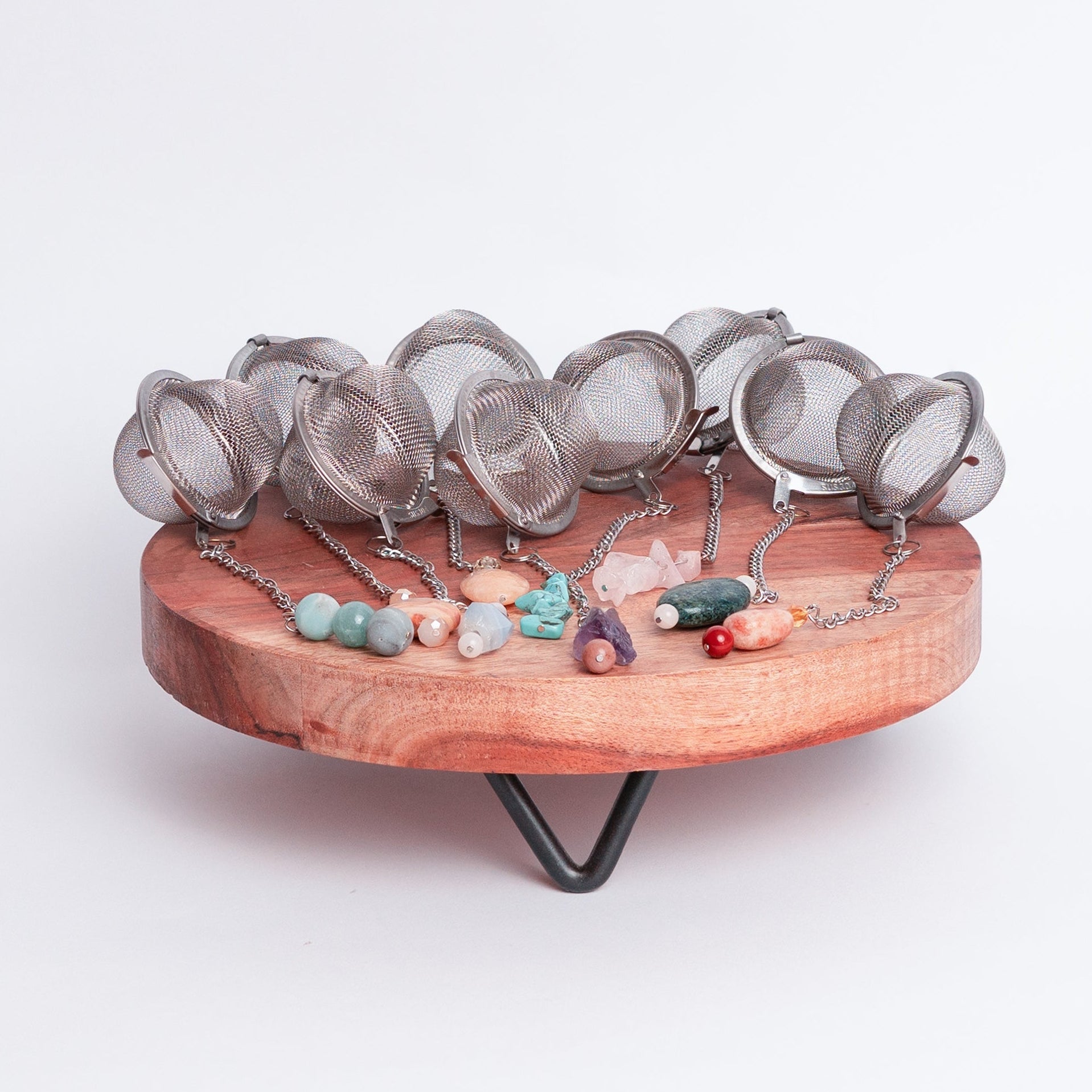 Handmade gemmed tea infuser ball from Megan’s Pantry featuring a large 2.5" stainless steel mesh for loose leaf tea. Each infuser includes a unique locally sourced gemstone charm. Crafted by Megan in Albuquerque NM this artisan tea accessory combines beauty and function and makes a perfect gift for tea lovers and wellness enthusiasts.