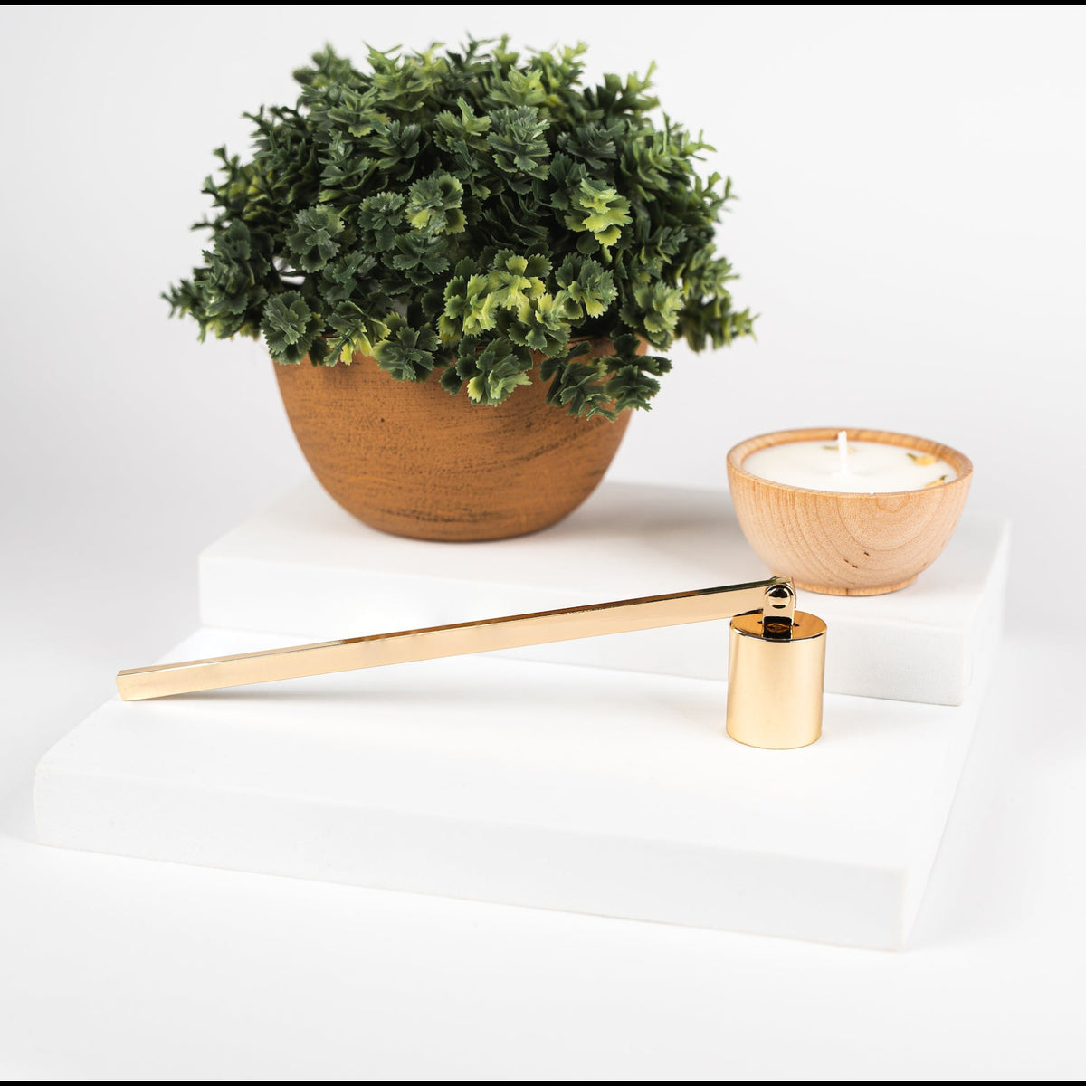 Gold candle snuffer from Megan's Pantry, an elegant candle care accessory