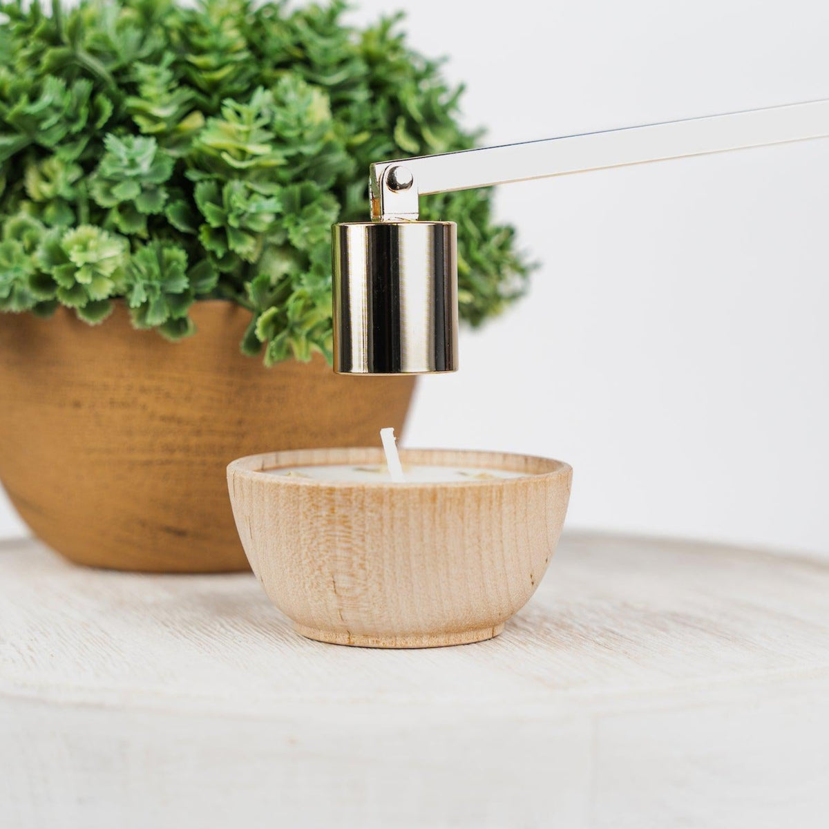 Gold candle snuffer from Megan's Pantry, an elegant candle care accessory