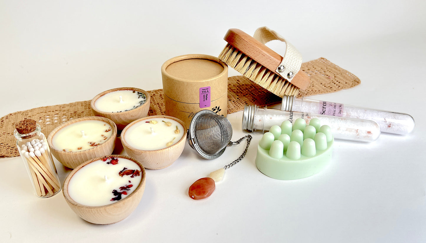 Megan’s Pantry Perfect Spa Day Gift Set featuring a 1 oz pouch of Relax herbal loose leaf tea, a gemmed stainless steel tea infuser, wooden aromatherapy tealight candles (set of 4), a box of matches, Serenity and Eucalyptus bath soaks (2 oz each), Peace triple butter body bar, and a natural bristle body brush — beautifully arranged for a luxurious spa day at home. Ideal wellness gift box for self-care, relaxation, stress relief, and thoughtful gifting.