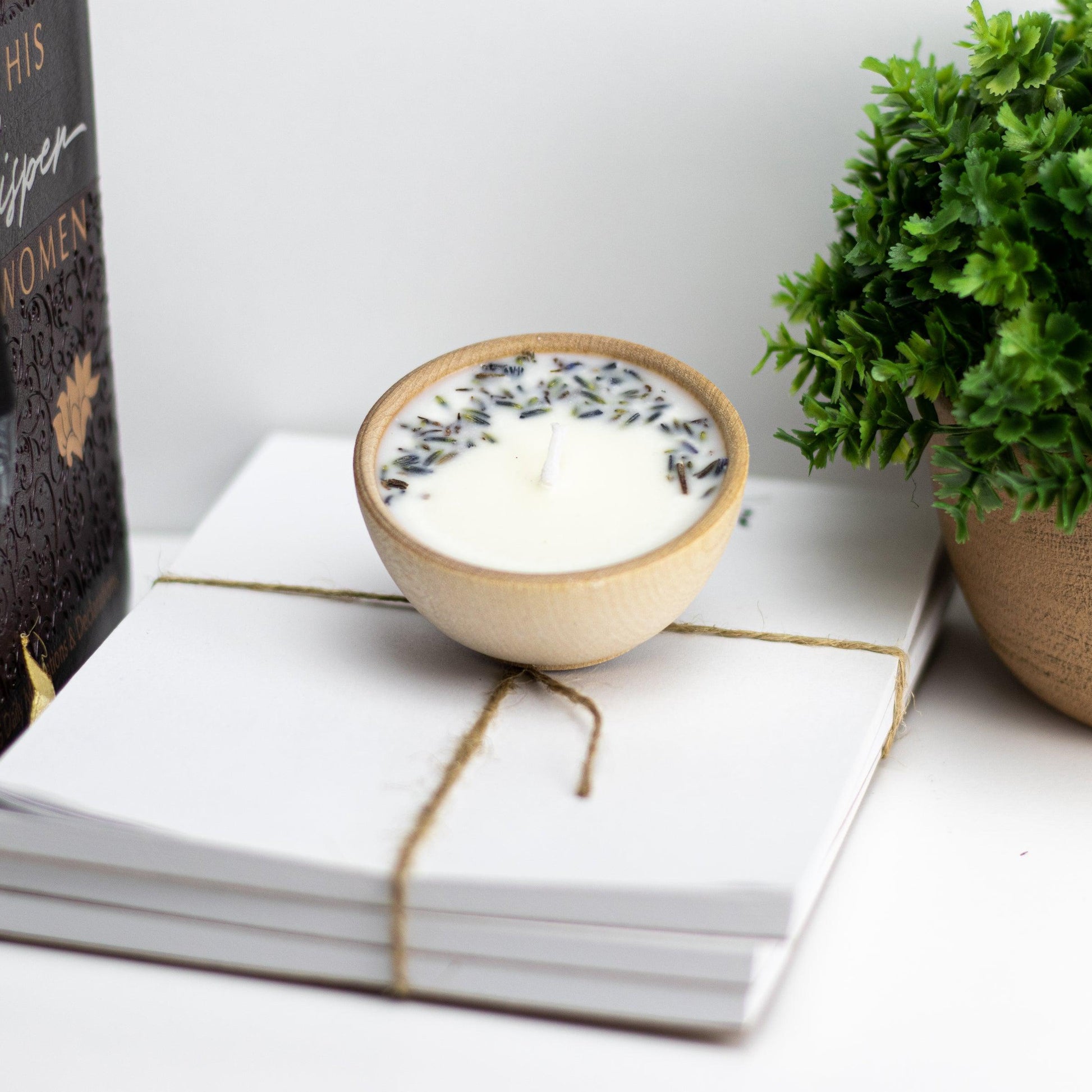 Set of four essential oil soy tealight candles from Megan’s Pantry in reusable wooden bowls, adorned with botanicals—natural, eco-friendly aromatherapy gift set.