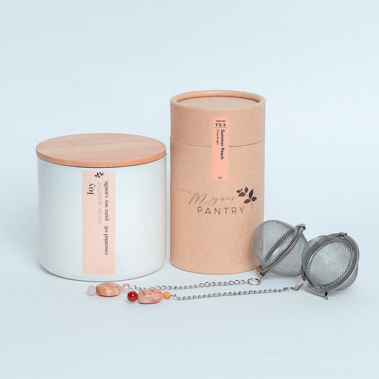 Share a moment of joy with the Tea for Two Gift Set from Megan’s Pantry — a charming tea and candle gift box perfect for birthdays, anniversaries, thank-you gifts, or simply brightening someone’s day. This thoughtfully curated set includes our best-selling Summer Peach Tea, a radiant Joy Essential Oil Candle, and two sparkling gemmed tea ball infusers for a beautiful, shared tea experience.