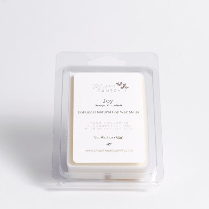 Hand-poured soy wax melts from Megan’s Pantry in recyclable containers, featuring six essential oil-infused fragrance options; clean, luxury aromatherapy for the home.