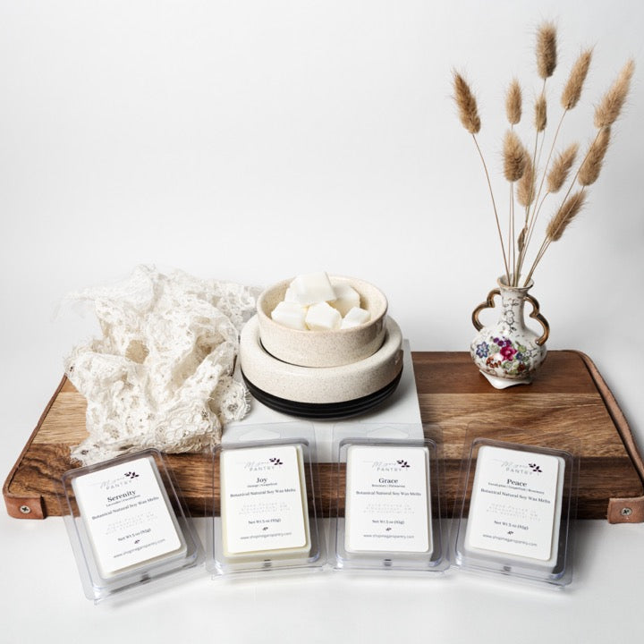 Hand-poured soy wax melts from Megan’s Pantry in recyclable containers, featuring six essential oil-infused fragrance options; clean, luxury aromatherapy for the home.