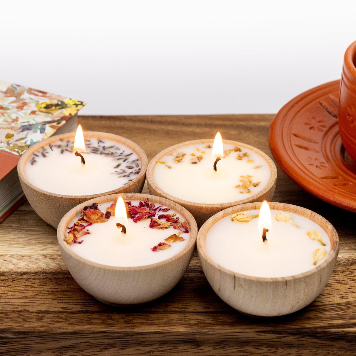 Set of two hand-poured soy tealight candles in reusable wooden bowls from Megan’s Pantry, infused with essential oils and botanicals for elegant, natural aromatherapy.