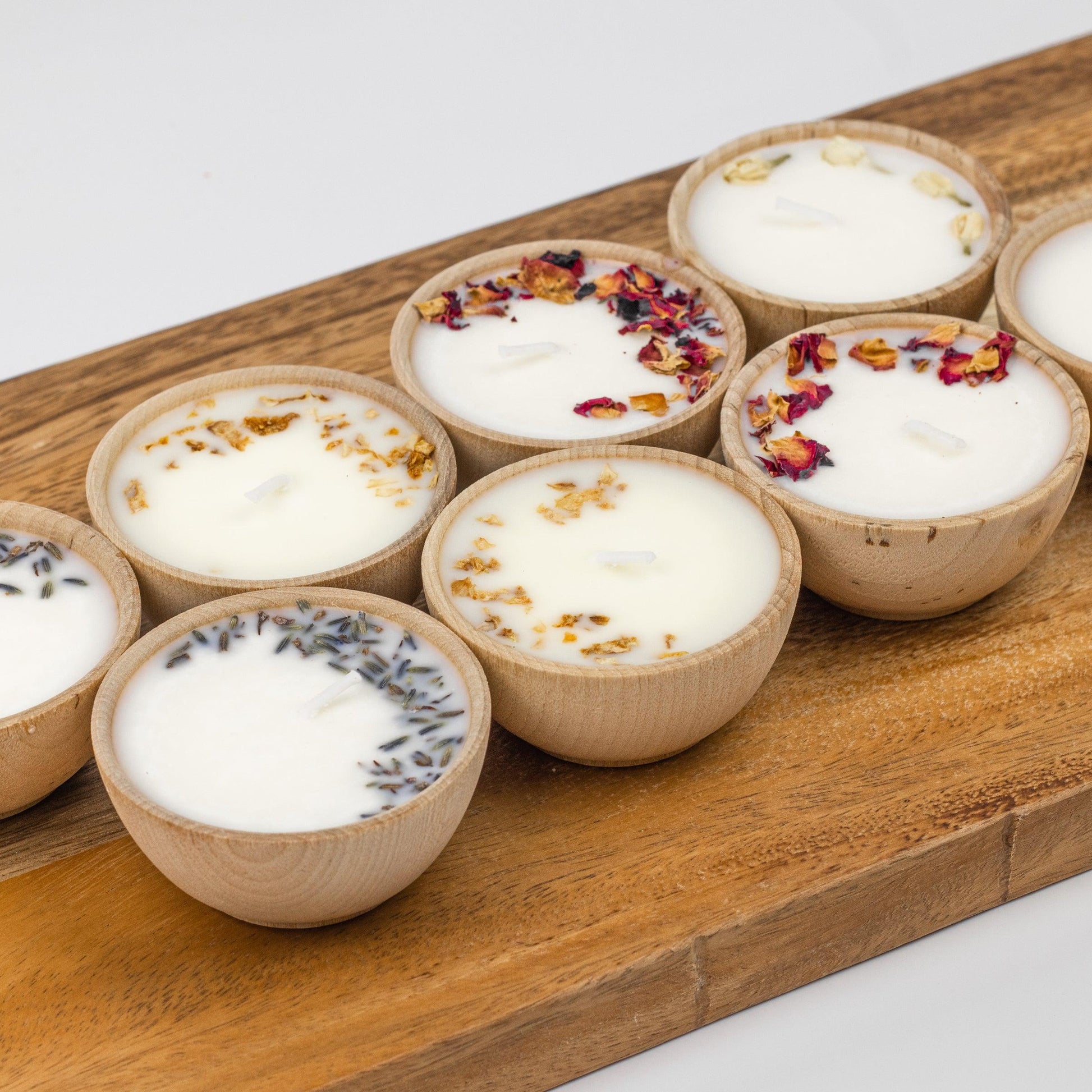 Set of two hand-poured soy tealight candles in reusable wooden bowls from Megan’s Pantry, infused with essential oils and botanicals for elegant, natural aromatherapy.