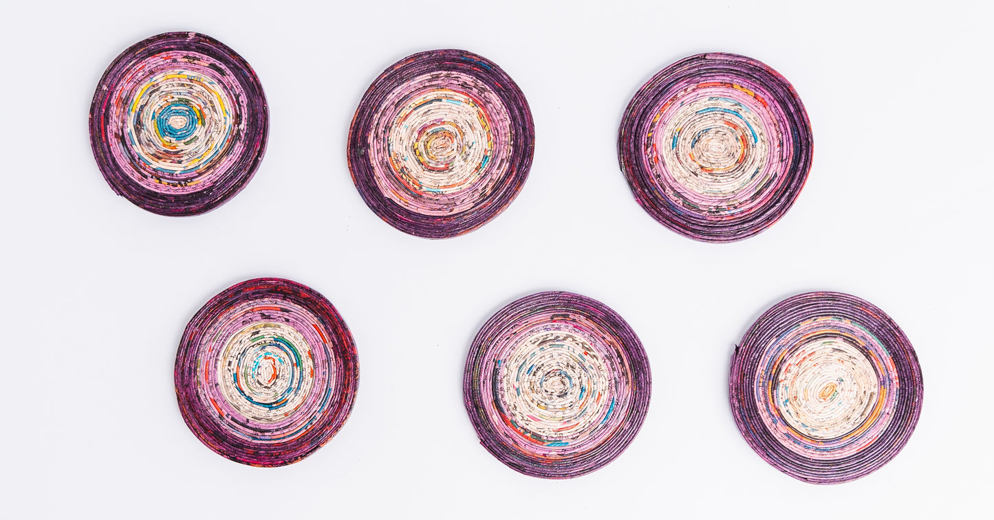 Megan’s Pantry Recycled Newspaper Coaster Set featuring six hand-crafted round coasters made from colorful upcycled newspaper, with a matching holder. Each eco-friendly coaster measures 4 inches in diameter and fits into a 4.5-inch holder. A sustainable and unique home décor gift, perfect for housewarmings, eco-conscious gifting, and colorful coffee table accessories