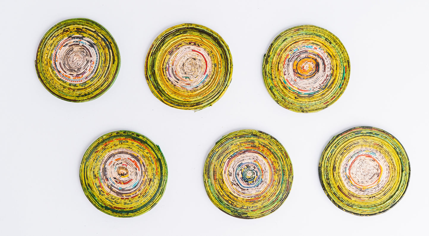 Megan’s Pantry Recycled Newspaper Coaster Set featuring six hand-crafted round coasters made from colorful upcycled newspaper, with a matching holder. Each eco-friendly coaster measures 4 inches in diameter and fits into a 4.5-inch holder. A sustainable and unique home décor gift, perfect for housewarmings, eco-conscious gifting, and colorful coffee table accessories