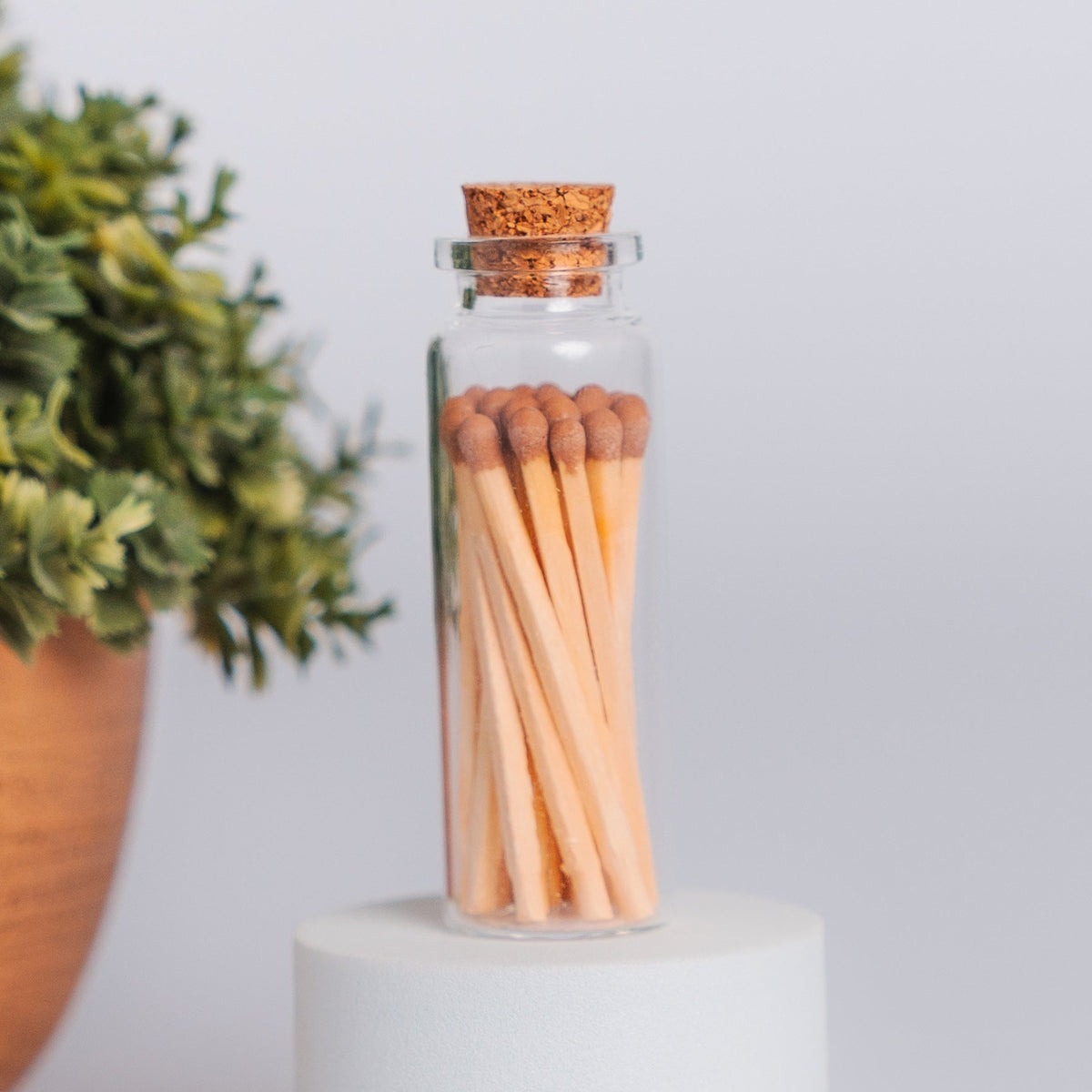 Glass vial of colored wooden safety matches with striker paper from Megan's Pantry
