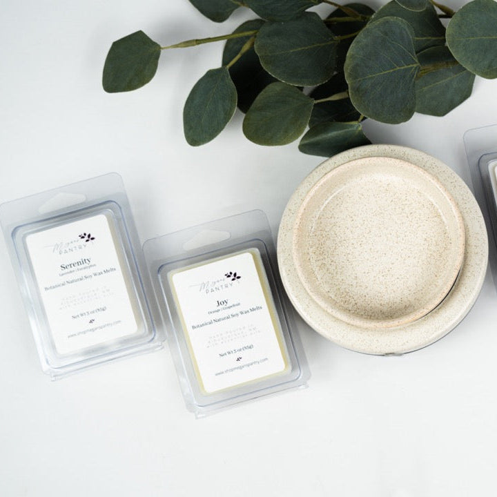 Hand-poured soy wax melts from Megan’s Pantry in recyclable containers, featuring six essential oil-infused fragrance options; clean, luxury aromatherapy for the home.