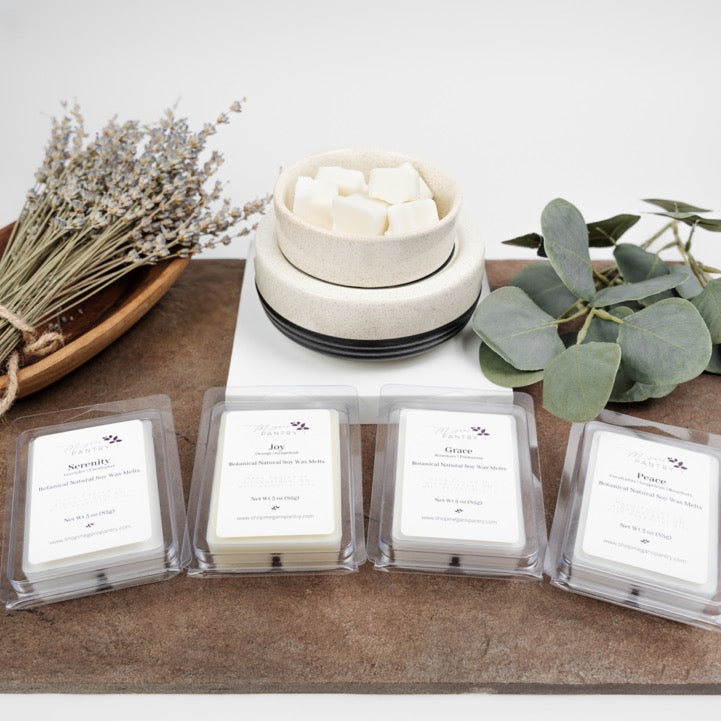 Hand-poured soy wax melts from Megan’s Pantry in recyclable containers, featuring six essential oil-infused fragrance options; clean, luxury aromatherapy for the home.